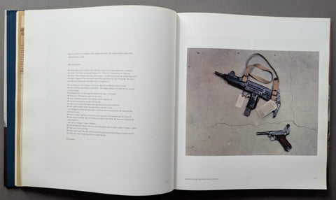 An open book spread showing printed text on the left page and a photograph on the right page of two handguns on a concrete surface.