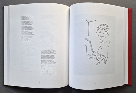 An open book laid flat on a dark gray surface, showing printed text and line drawings on white pages.