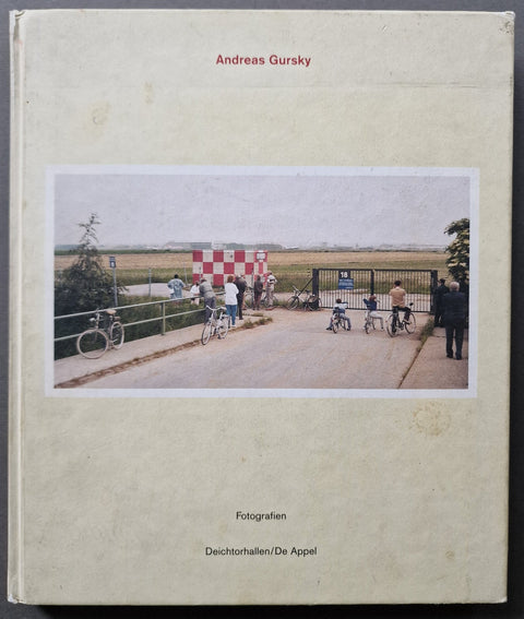 The photobook cover of Andreas Gursky Fotografien in off white with a photo of a park scene with lots of people on bikes.
