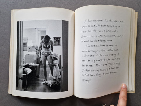An open book showing a black-and-white photograph of a woman in a room on the left page and handwritten text on the right page.