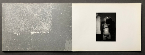 Small black and white photograph on a white card with a gray border, all set against a dark background.