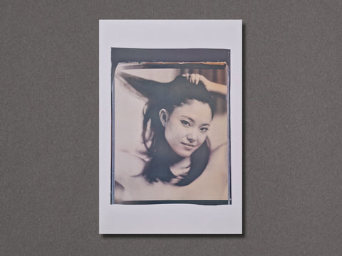 A square photographic art print featuring a black and white portrait of a woman with dark hair, presented with a wide white border 