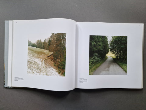 An open book spread showing two photographs of forest landscapes