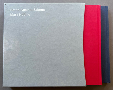 Books titled 'Battle Against Stigma' by Mark Neville, one with a blue cover and one with a red cover, in a grey slipcase.
