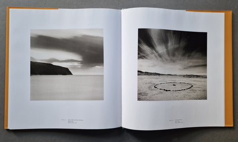 An open book showing two black-and-white landscape photographs