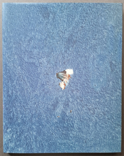 The photobook cove of Richard Misrach, titled Misrach with a large-scale negative photo of a person of the beach.