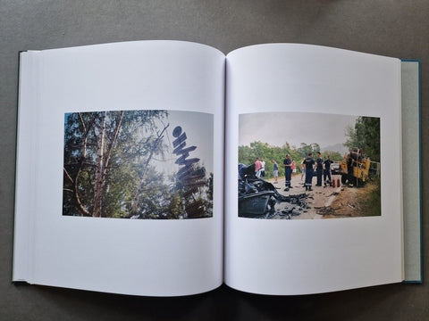 An open book showing two printed photographs spread across the white pages.