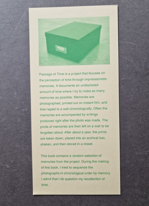 A printed booklet or book cover titled "Passage of Time" with a pale green illustration of a storage box at the top and several paragraphs of black text below, photographed against a dark textured background.