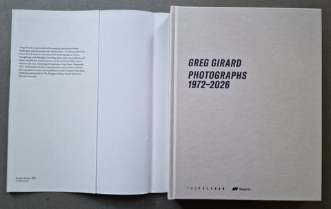 The cover underneath the dust jacket with the title 'GREG GIRARD PHOTOGRAPHS 1972-2026' in black on a white textured background.