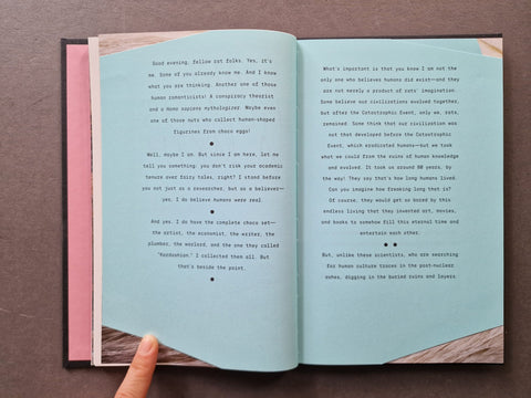  The book pages are a pale blue-green colour with black text and small decorative bullet points.