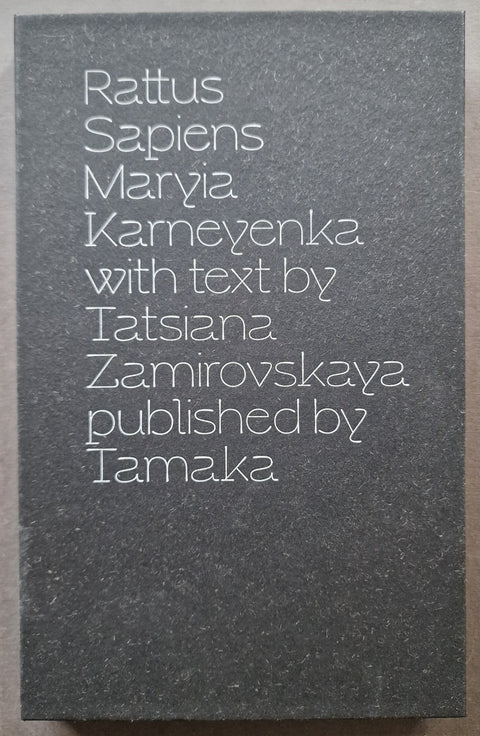 A square dark gray book coverwith white text reading 'Rattus Sapiens Maryia Karneyenka with text by Tatsiana Zamirovskaya published by Tamaka' 