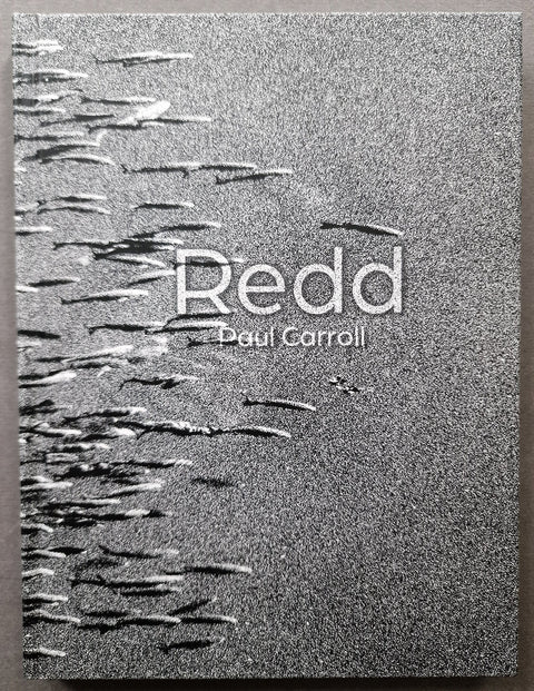The cover of Redd by Paul Carroll in grainy gray showing an underwater photo of fish swimming.