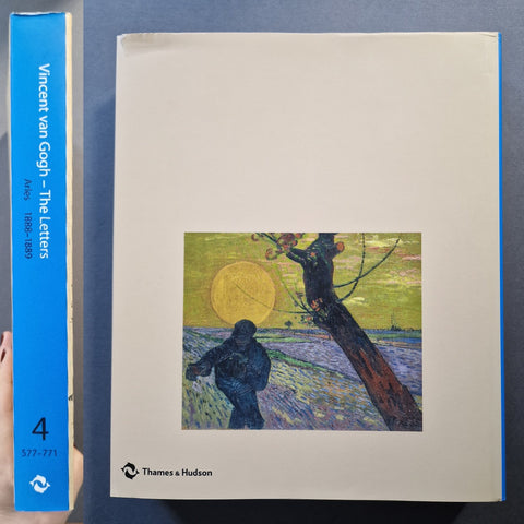 Vincent van Gogh - The Letters volume 4 book by Thames & Hudson, showing the blue spine and front cover with a Van Gogh painting on the cover, held next to a hand.