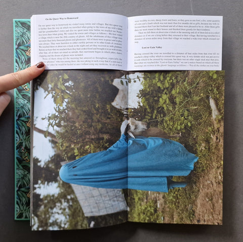  The left page has black text on white paper, and the right page shows a large photograph of a person in a bright blue top standing outdoors near water and trees.