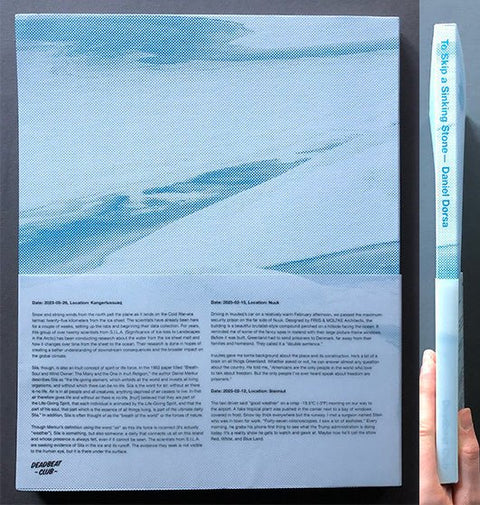 A person's hand holds the book to-skip-a-sinking-stone by daniel-dorsa next to a a photo of the back cover of a blue water-and-sand landscape and text, including the title 'Tio Skip a Sinking Stone- Daniel Dorsa'.