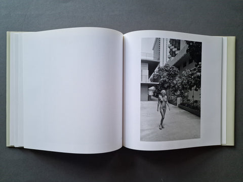 An open book, showing a black-and-white architectural photograph printed on the right page and blank white pages on the left.