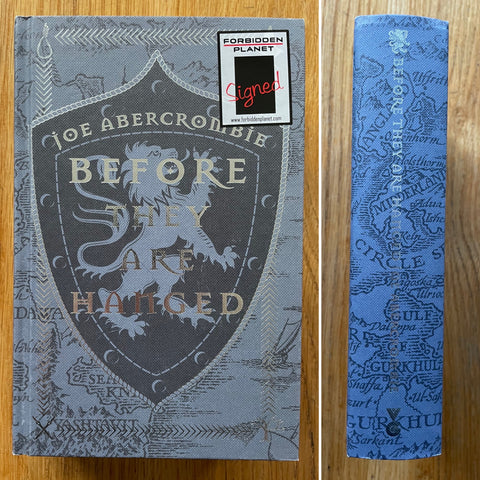The book cover of Before They Are Hanged by Joe Abercrombie. In hardcover blue.