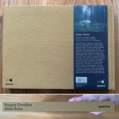The photography book cover of Alone Street by Gregory Crewdson. In hardcover mustard.