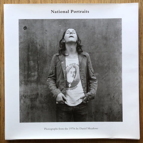 The photography book cover of National Portraits by Daniel Meadows. Hardback in white with B&W image of a man standing in the centre.