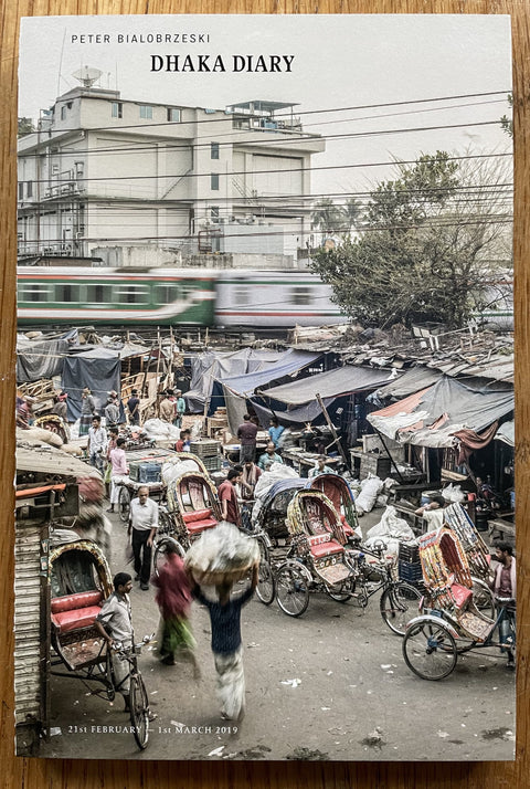 This is the cover of Dhaka Diary by Peter Bialobrzeski with a cityscape photograph on the cover