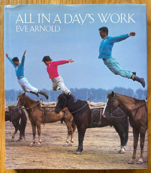 The photgraphy book cover of All in a Day's Work by Eve Arnold. In dust jacketed hardcover. Signed to title page.