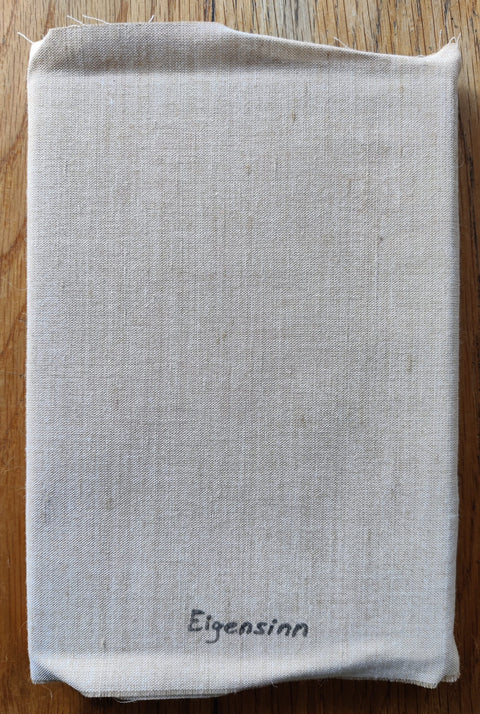 The photography book cover of It was snowing outside (and it took her two days to notice) by Jule Wild. In softcover wraparound linen fabric.