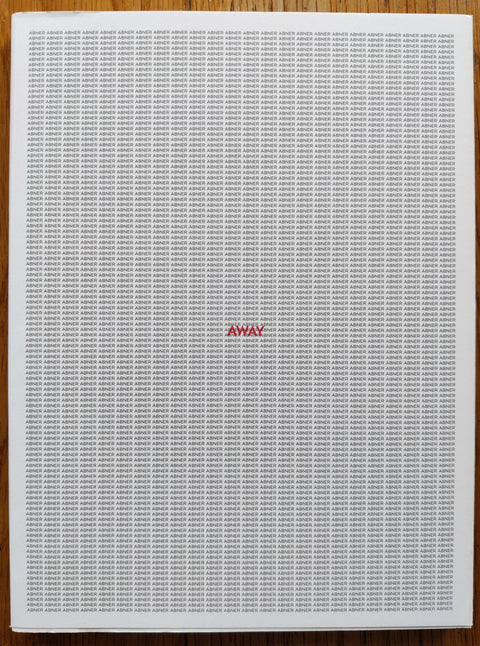 The photography book cover of Away by Abner Nolan. In dust jacketed softcover white.