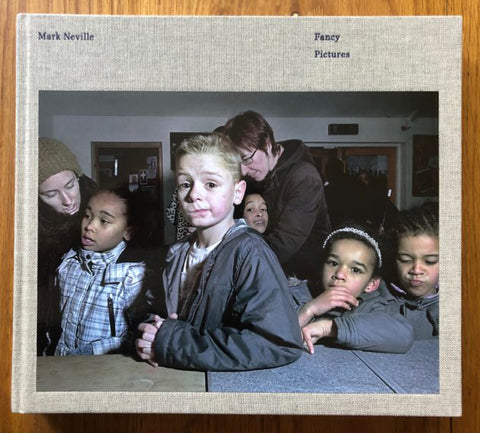 The photography book cover of Fancy Pictures by Mark Neville. Hardback with image of young children on the cover.