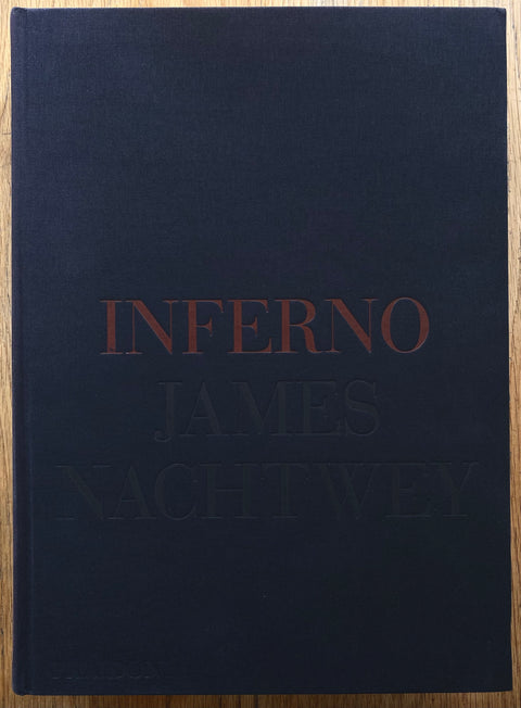 The photography book cover of Inferno by James Nachtwey. In linen hardcover with text.