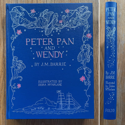 The book cover of Peter Pan and Wendy by J M Barrie. In hardcover blue.