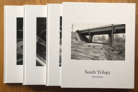 The photography book cover of South Trilogy - South Central - South East - Greater Atlanta by Mark Steinmetz. Hardback in white. Signed.