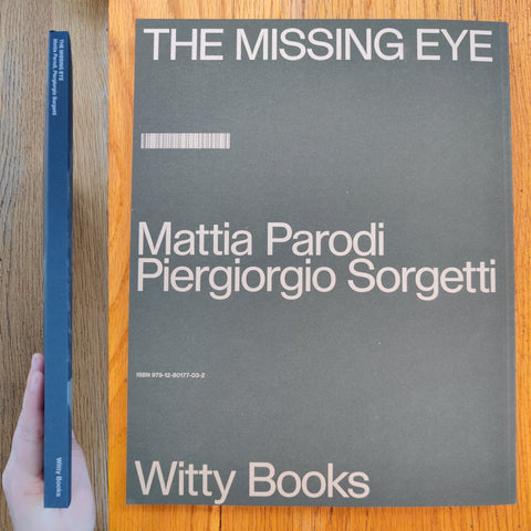 The photography book cover of The Missing Eye by Mattia Parodi and Piergiorgio Sorgetti. In softcover green with a butterfly.
