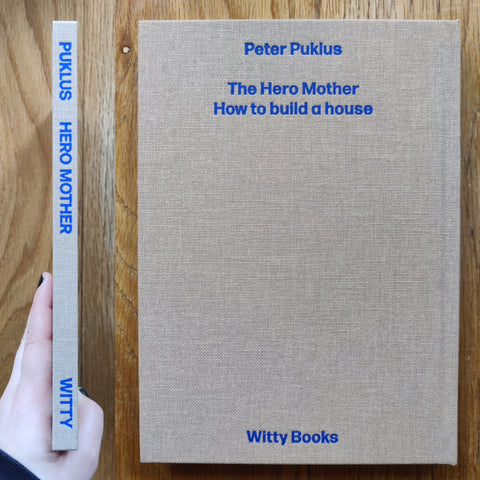 The photography book cover of The Hero Mother - How to build a house by Peter Puklus. In hardcover beige.