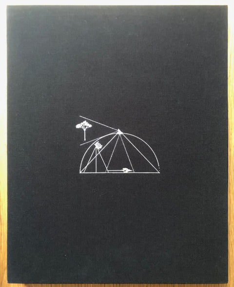 The photography book cover of Tent Camera by Abelardo Morell. Hardback in black with white line drawing in the middle.