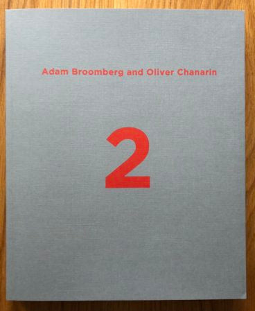 The photography book cover of War Primer 2 by Adam Broomberg and Oliver Chanarin. Paperback grey cover with red text.