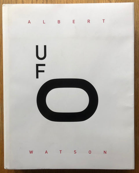 The photography book cover of UFO: Unified Fashion Objectives by Albert Watson. Hardback in white with large O in title.