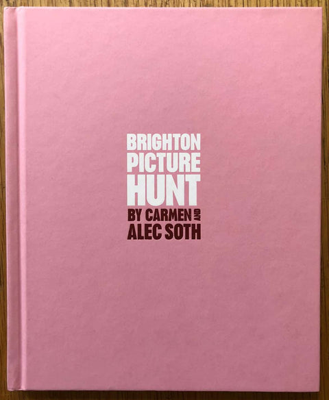 The photography book cover of Brighton Picture Hunt by Carmen and Alec Soth. Hardback in pink with title in the middle. Signed.