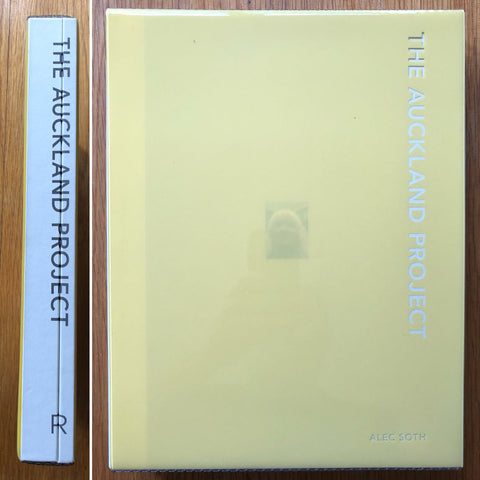 The photography book cover of The Auckland Project by Alec Soth and John Gossage. Hardback in yellow and white.