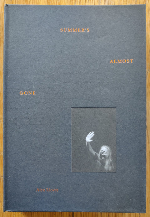 The photobook cover of Summer's Almost Gone by Alex Llovet. In hardcover black