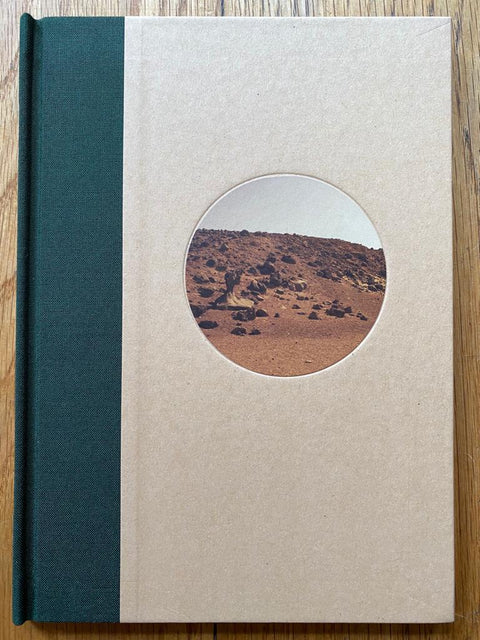 The photography book cover of Captains of the Dead Sea by Alia Malley. Hardback in beige with a dark green spine and circle photograph of the desert. Signed.