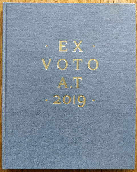 The photography book cover of Ex Voto by Alus Tomlinson. In hardcover grey.