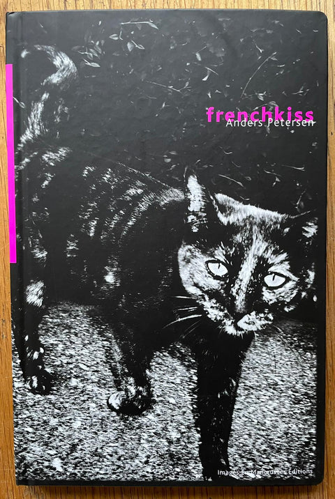 The photography book cover of Frenchkiss by Anders Petersen. Hardback in B&W with hot pink title.