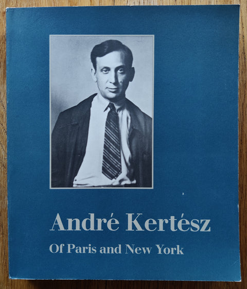 The photobook cover of Of Paris and New York by Andre Kertesz. In softcover blue.