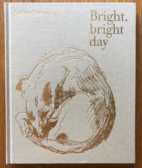 The photography book cover of Bright Bright Day by Andrey Tarkovsky. Hardback beige with gold design.
