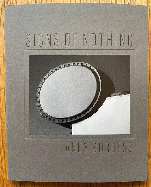 The photography book cover of Signs of Nothing by Andy Burgess. Paperback in grey. Signed.