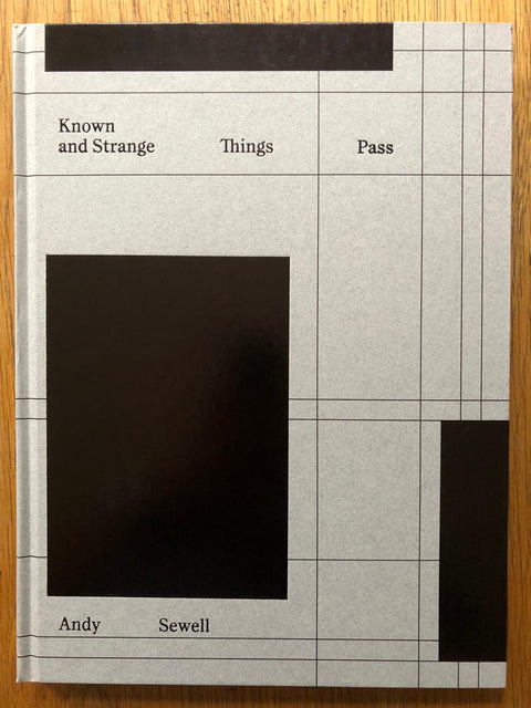 The photography book cover of Known and Strange Things Pass by Andy Sewell. Hardback with grid on the cover and 3 large black rectangles. Signed.