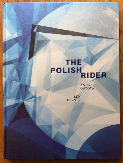 The photography book cover of The Polish Rider by Anna Ostoya and Ben Lerner. Hardback in blue and white.