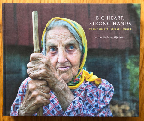 The photobook cover of Big Heart, Strong Hands by Anne Helene Gjelstad. Hardback with image of an elderly lady with a yellow scarf.
