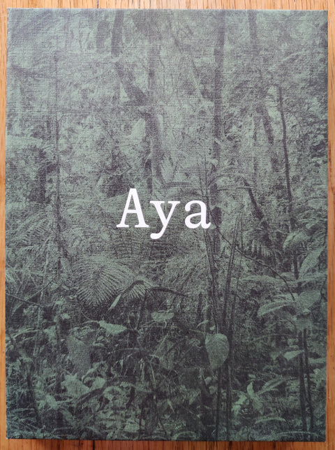 The photography book cover of Arguiñe Escandón and Yann Gross. In wraparound hardcover with green leafs.