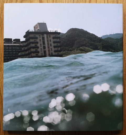 The photography book cover of Half awake and half asleep in water by Asako Narahashi. Hardback with image taken from the water. 